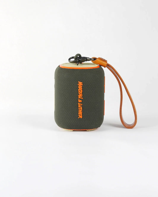 Belleville speaker in olive green, showcasing its rugged textile finish and sleek cylindrical design for an urban lifestyle.