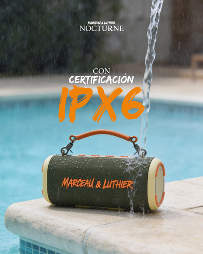 Marceau & Luthier Nocturne portable speaker resting poolside while being splashed with water, demonstrating its IPX6 waterproof certification.