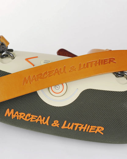 Close-up of the premium brown leather strap embossed with the Marceau & Luthier logo on the Rive Droite speaker.